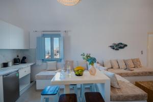 a kitchen and living room with a table and a couch at Begi Luxury Villas in Karterados