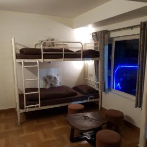 a room with two bunk beds and a window at help hostel in Mussoorie +13 photos