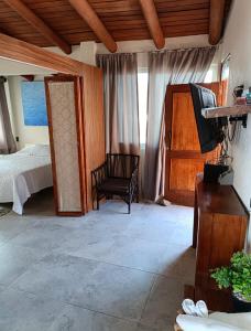 a bedroom with a bed and a tv in a room at la vista the view in Zihuatanejo