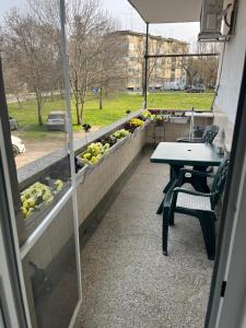 a patio with a table and benches and vegetables at Apartment Tzankov in Vidin