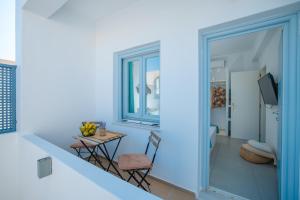 a room with a table and chairs and a window at Begi Luxury Villas in Karterados
