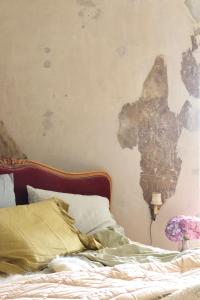a bedroom with a bed with a map on the wall at Chateau Chemilly in Chemilly