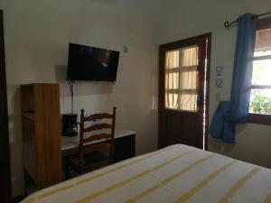 a bedroom with a bed and a desk and a television at Don Pablo bed and breackfast in Copán Ruinas