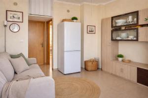 a white refrigerator in a living room with a couch at Dimora del Sole in Vasto