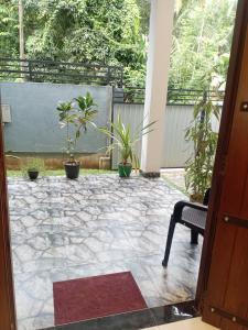 an open door to a patio with potted plants at Hidden Pearl in Kandy