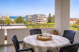 a table with chairs and wine glasses on a balcony at Dimora del Sole in Vasto