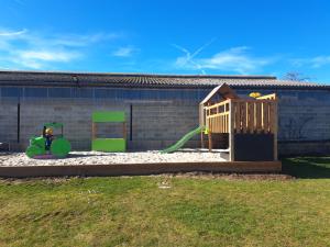 a playground with a slide and a play structure at B&B Hoeve Terwinghe in Gingelom