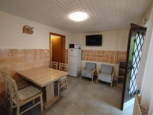 a kitchen and dining room with a table and chairs at Apartma Silvester in Bovec