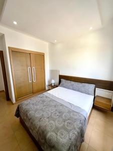 a bedroom with a large bed and a wooden cabinet at Visit Chamal - Horizon View in Oued Laou +18 photos