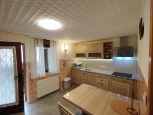 a kitchen with wooden cabinets and a counter top at Apartma Silvester in Bovec