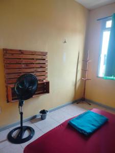 a room with a fan in the corner of a room at Casa das Hortas in São Luís