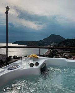 a hot tub on a balcony with a view of the ocean at Baywatch Apartmans in Brca