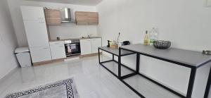 a kitchen with a table in the middle of a room at Das Haus in Furth an der Triesting