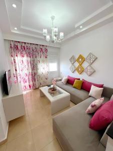 a living room with a couch and a table at Visit Chamal - Horizon View in Oued Laou
