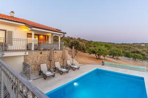 a villa with a swimming pool on a balcony at Villa Lareva - sunset view in Ustrine