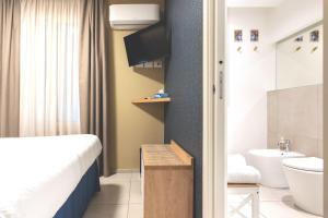 a bathroom with a bed and a toilet and a sink at Taormina Town - Guesthouse Sicily in Taormina