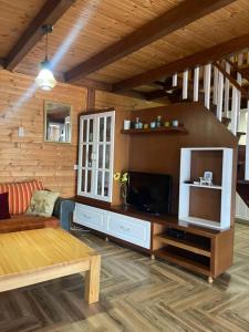 a living room with a couch and a tv at Sol Apartments in Durrës