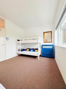 a bedroom with two bunk beds and a window at Two Floor Flat in Town Center in Kenilworth