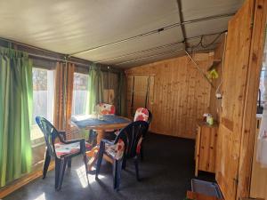 a dining room with a table and chairs in a house at Mobilheim am Hafen in Gager +3 photos