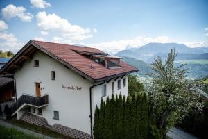 a small white house with a red roof at Rumpelehof in Villandro +7 photos