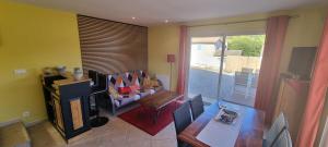 a living room with a couch and a table at La Casa Liberta in Salavas +10 photos