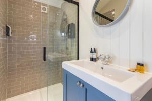 a bathroom with a sink and a shower at Bankhead Shepherds Hut in Stirling
