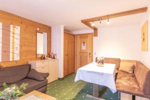 a living room with a couch and a table at Bergidyll & Hotel Trofana in Leutasch