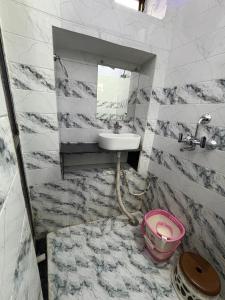 a bathroom with a sink and a mirror at Stay in Someshwar in Varanasi