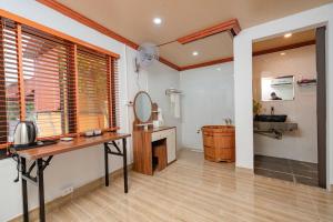 a bathroom with a vanity and a mirror and a sink at Dreamy Homestay in Xuân Sơn