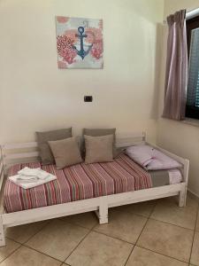 a bed with pillows on it in a room at L'Ulivo in Formia