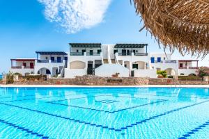 a swimming pool in front of a villa at Aegean Verde Retreat in Sounio