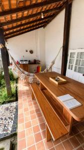 a wooden table in a room with a hammock at Casa Igara Hostel in Belém