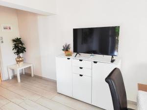 a living room with a tv on a white dresser at Sofia's Guest House in Levkákia