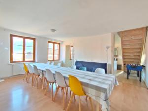 a large dining room with a long table and chairs at Duplex avec vue au centre de Bussang in Bussang