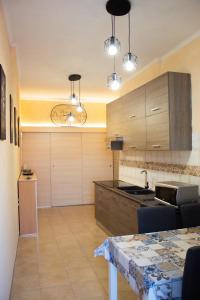 a kitchen with wooden cabinets and a table with chairs at Domus Mazzini in Tivoli +15 photos