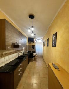 a large kitchen with wooden cabinets and a table at Domus Mazzini in Tivoli