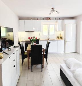 a kitchen and dining room with a table and chairs at Sofia's Guest House in Levkákia