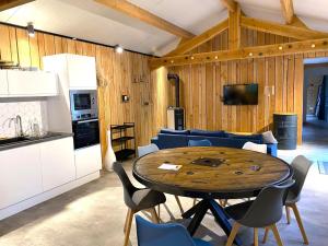 a kitchen and a dining room with a table and chairs at Chez mathilde et sÉbastien in Rubigny