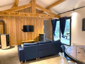 a living room with a blue couch and a table at Chez mathilde et sÉbastien in Rubigny