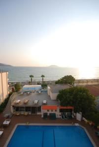 a view of a swimming pool with the ocean in the background at Malhun Hotel in Fethiye +2 photos
