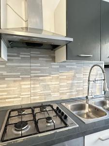 a kitchen with a stove top and a sink at Venice Night 11 in Mestre +89 photos