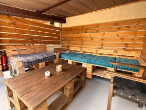 a room with benches and tables in a wooden room at VentallóLEscala. WiFi. Rooftop w stunning views in Ventalló