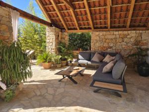an outdoor patio with a couch and a table at Mai's Cottage in Stari Grad