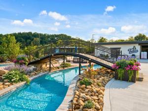 a bridge over a swimming pool in a resort at Smith Creek Resort - Exclusive Waterpark Included in Sevierville