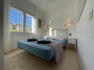 a bedroom with two beds and a window at Villa Riells Mar in L'Escala +24 photos