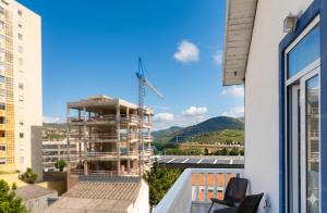 a view of a building under construction from a balcony at Casa do Salgueiral Douro in Peso da Régua