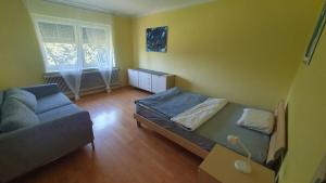 a living room with a bed and a couch at Ferienwohnung Wiener in Marchtring