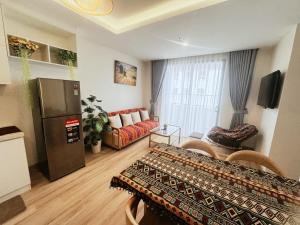 a living room with a couch and a refrigerator at Rose Home in Lao Cai