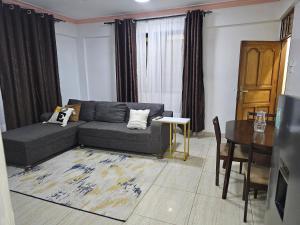 a living room with a couch and a table at Kim'sPlace in Mombasa