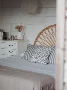 a bed with a wooden headboard and a pillow on it at Carrière Sauvage in Pont-Aven +84 photos